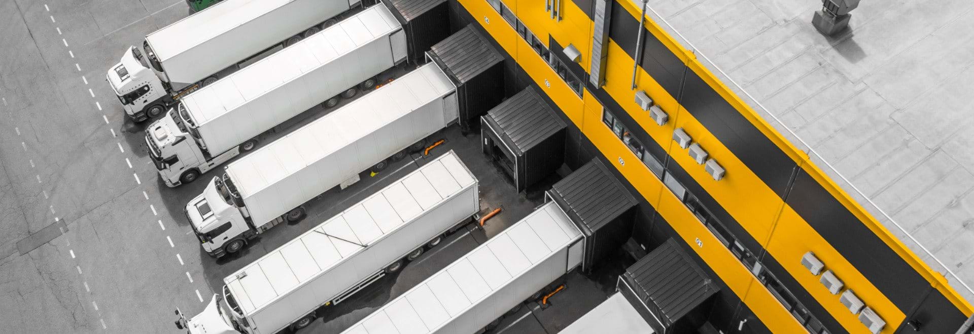 Trucks lined up in front of a warehouse